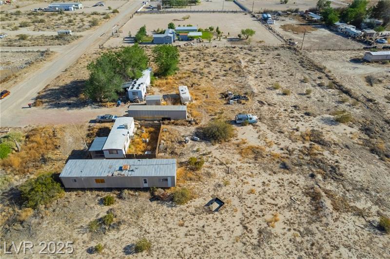 2350 Shawnee Street Wide view of sandy desert land with snow-capped mountains in the background, showcasing a ranch property in Sandy Valley NV.